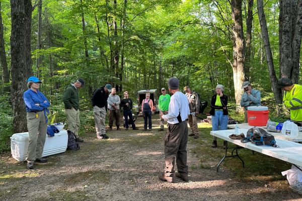 A group of volunteers doing trail maintenance meet up as a group prior to the work day.