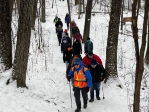 Waukesha/Milwaukee County Chapter Volunteer Becky B. leads a snowy First Day Hike in 2022.