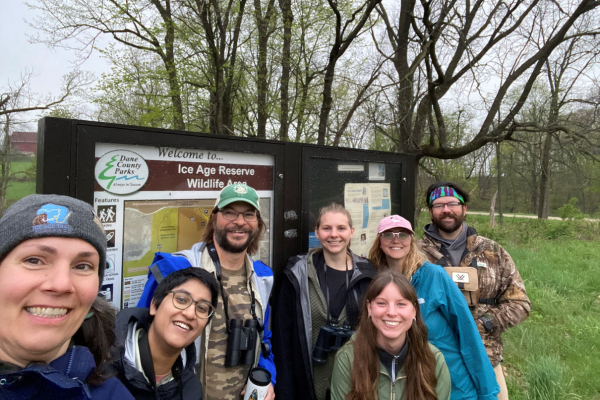 A group of people take a selfie together before a birding hike.