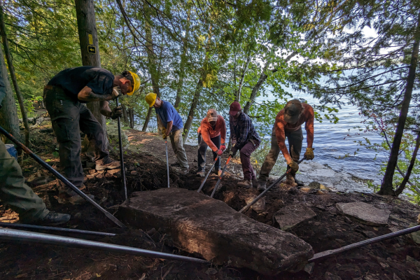 Volunteers work together to move a large dolomite slab. Photo by Patrick Gleissner.