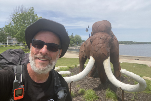 Photo of Dale "Trail Boomer" Morehouse in front of the Wooly Mammoth statue at Otumba Park in Sturgeon Bay, WI. Photo by Dale Morehouse.