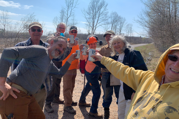 A group of volunteers cheers beers.