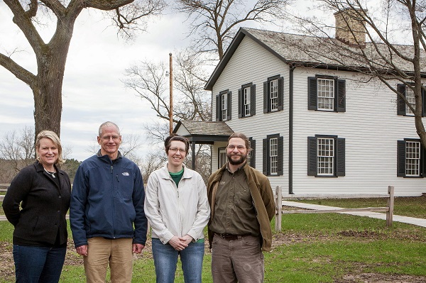 Non-profit partners all smiles in front of the Historical Indian Agency House. Photo courtesy of Natural Heritage Land Trust.