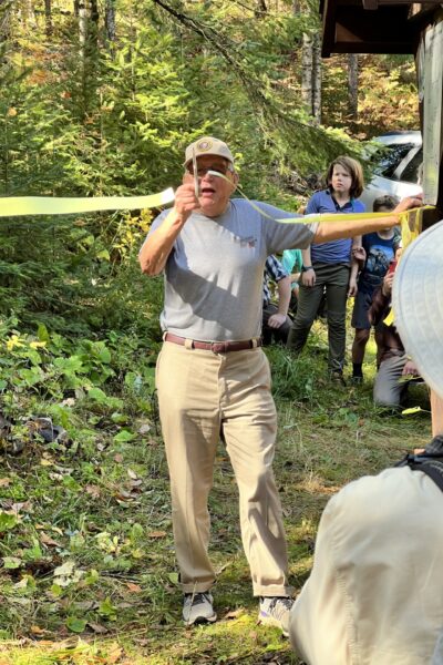 Bob Rush, a dedicated Ice Age Trail supporter and the driving force in rebuilding the Rib Lake Segment, cuts the ribbon to officially re-open the segment! Photo by Troy Stoneberg.