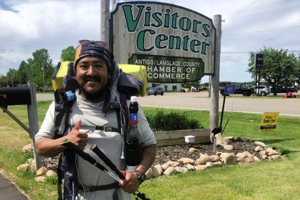 Ruiz posing in front of the Visitors Center in the Antigo/Langlade County trail community. Photo by Ernie Ruiz.